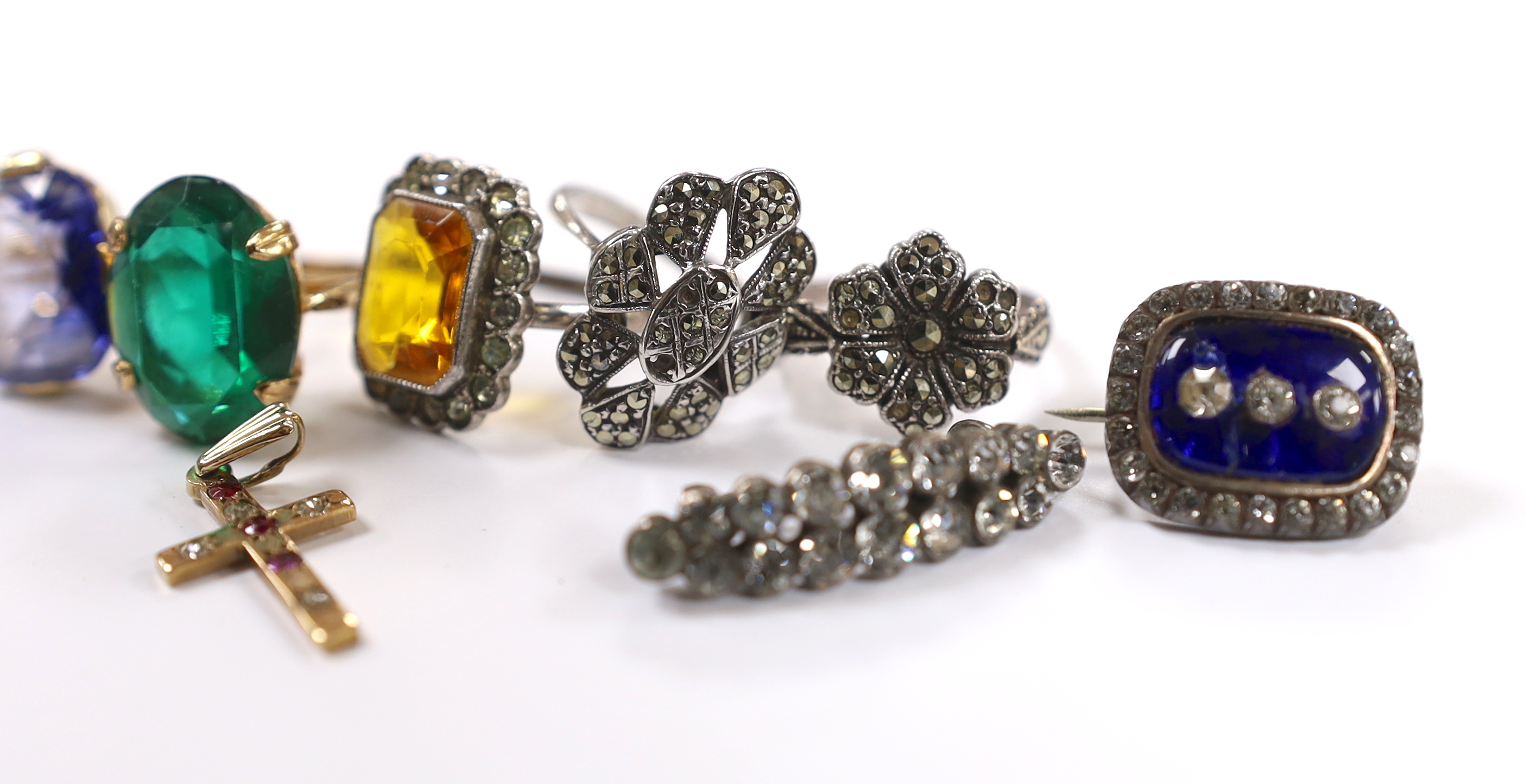 A 9ct and single stone rectangular cushion cut synthetic sapphire set ring, a 9ct gold and gem set cross pendant and a small group of early to mid 20th century jewellery including marcasite and paste set.